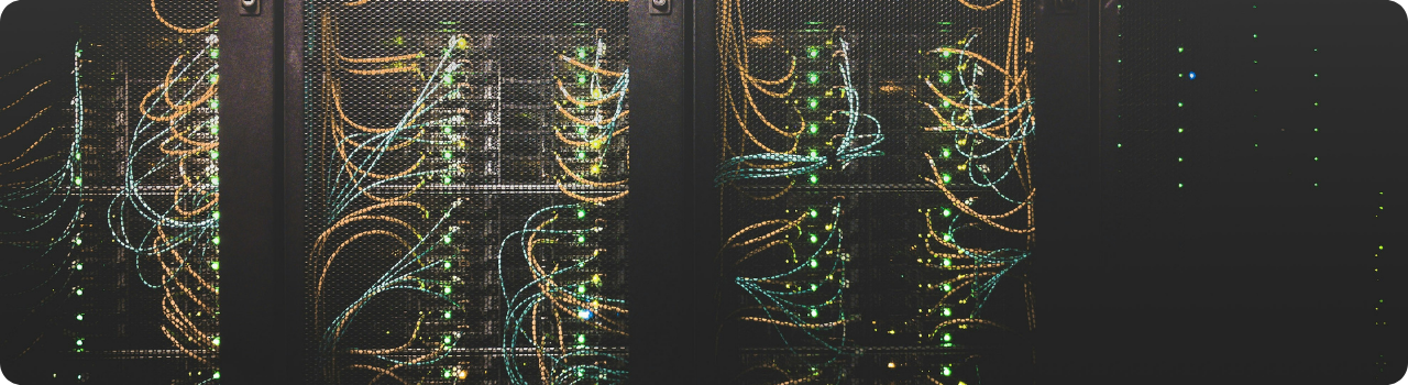 Data centre racks strung with fibre optic cables, the physical infrastructure behind the AI trade.