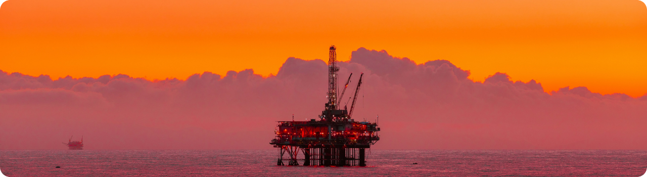 Offshore oil platform at sunset, illustrating the physical crude market behind Dated Brent pricing