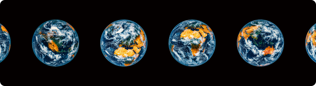 A row of Earth globes on black, each rotated to show a different continent, from the Americas to Europe, Africa and Asia.